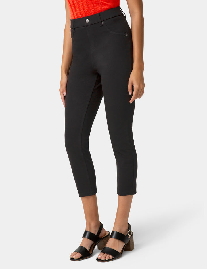 Person wearing black capri pants and sandals