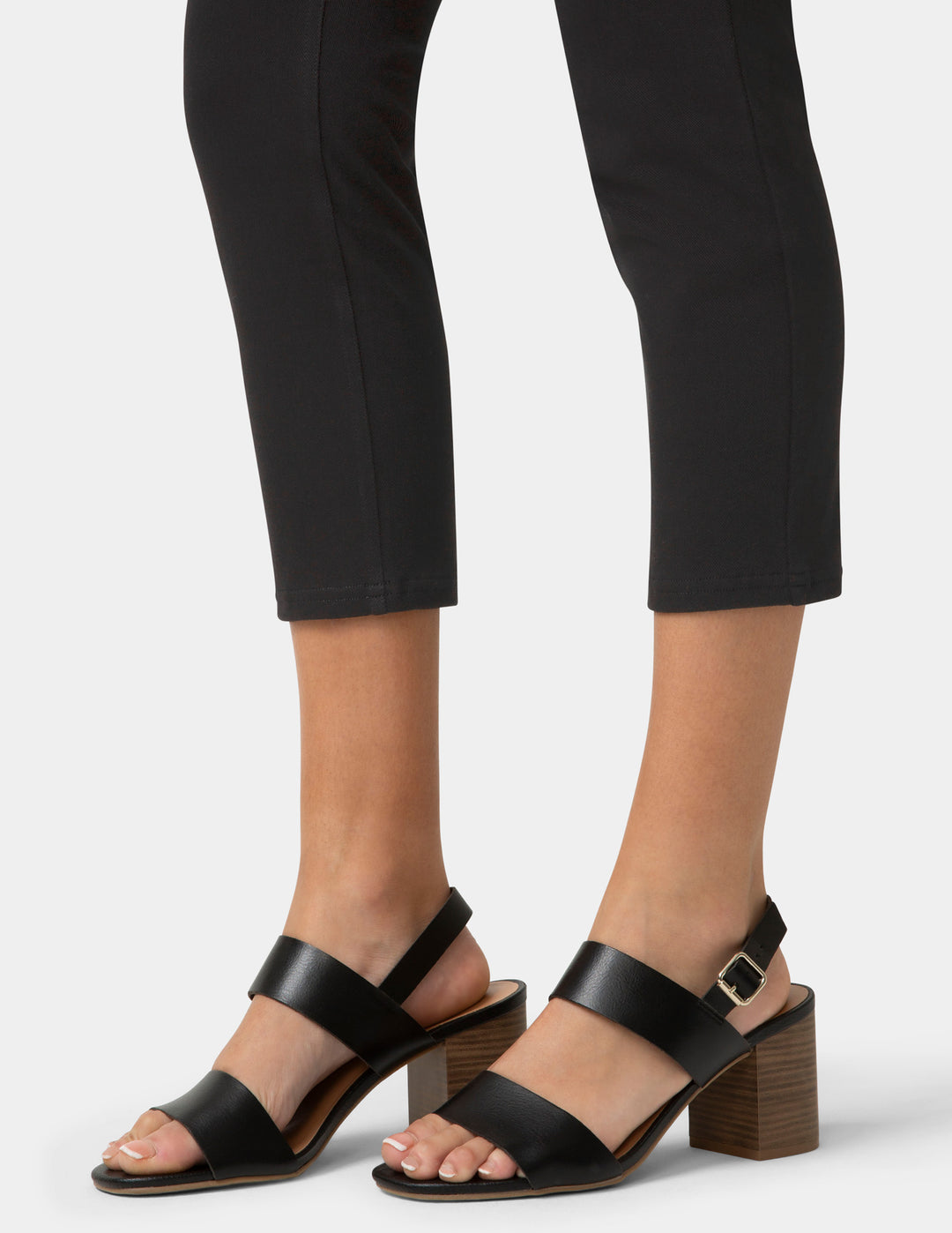 Person wearing black capri pants and sandals