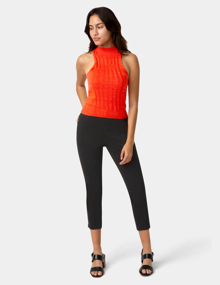 Woman wearing black capri pants and a sleeveless top