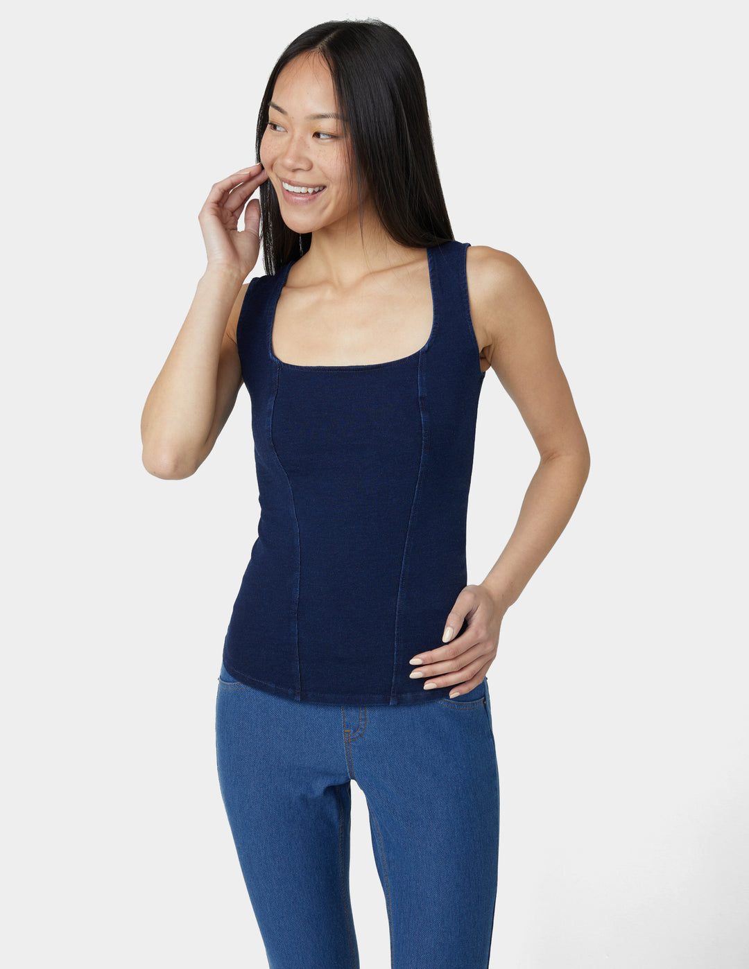 Woman wearing a navy compression garment against a white background