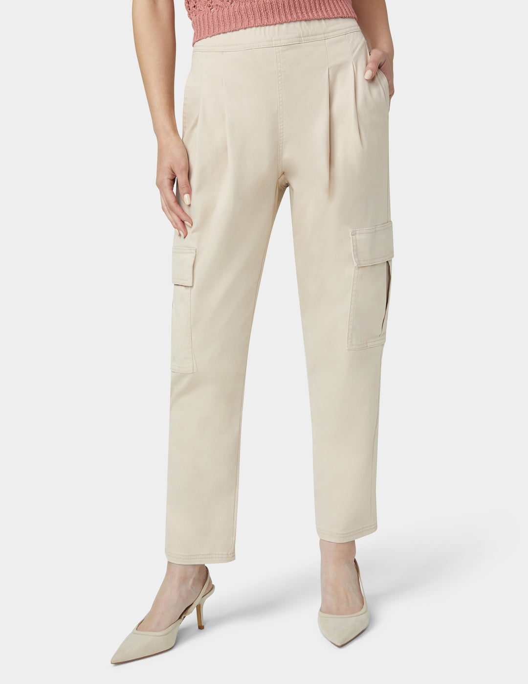 Beige cargo pants worn by a person on a white background