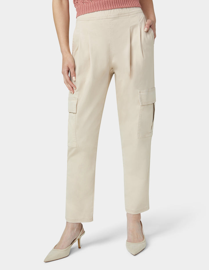 Beige cargo pants worn by a person on a white background