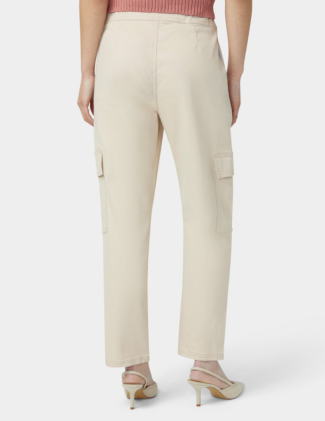 Beige cargo pants worn by a person on a white background