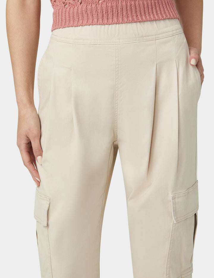 Beige cargo pants worn by a person on a plain background