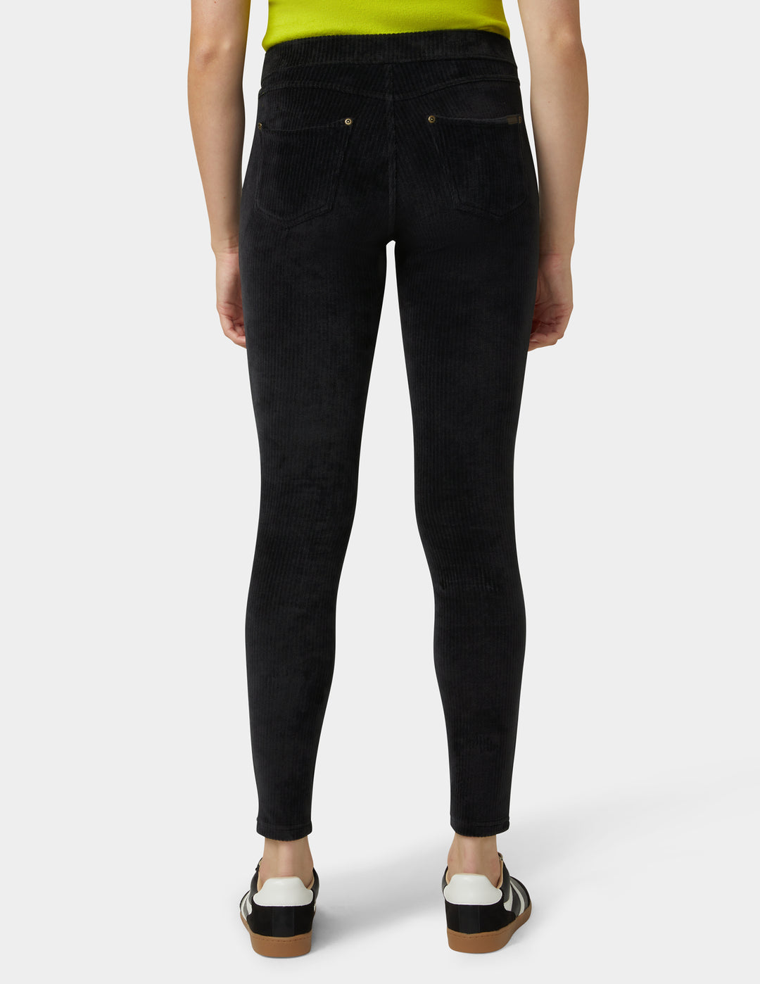 Person wearing black jeans on a white background