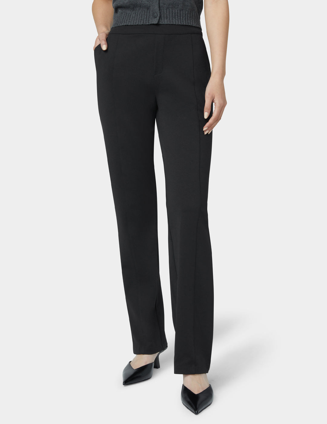 Black pants worn by a person on a white background