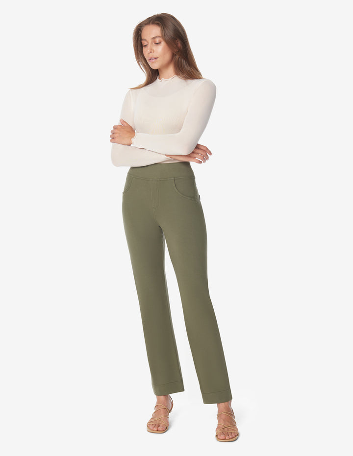 A woman wearing a white top and olive green high-rise straight-leg jeans with mock front pockets and real back pockets.