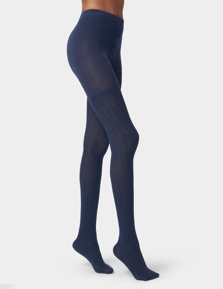 Navy blue tights worn by a person on a white background