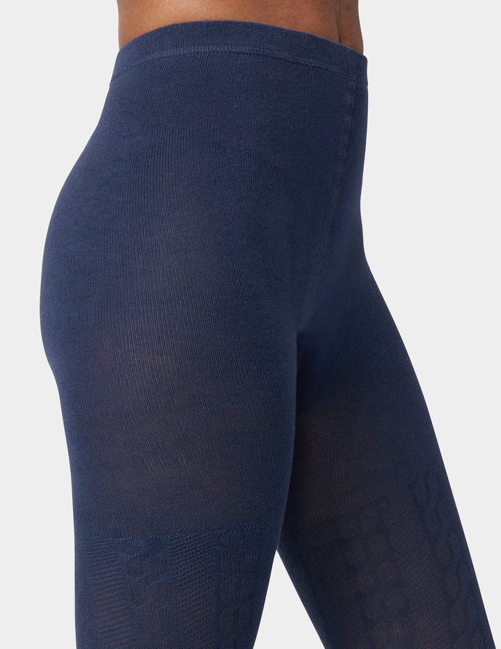 Navy blue leggings worn by a person on a white background