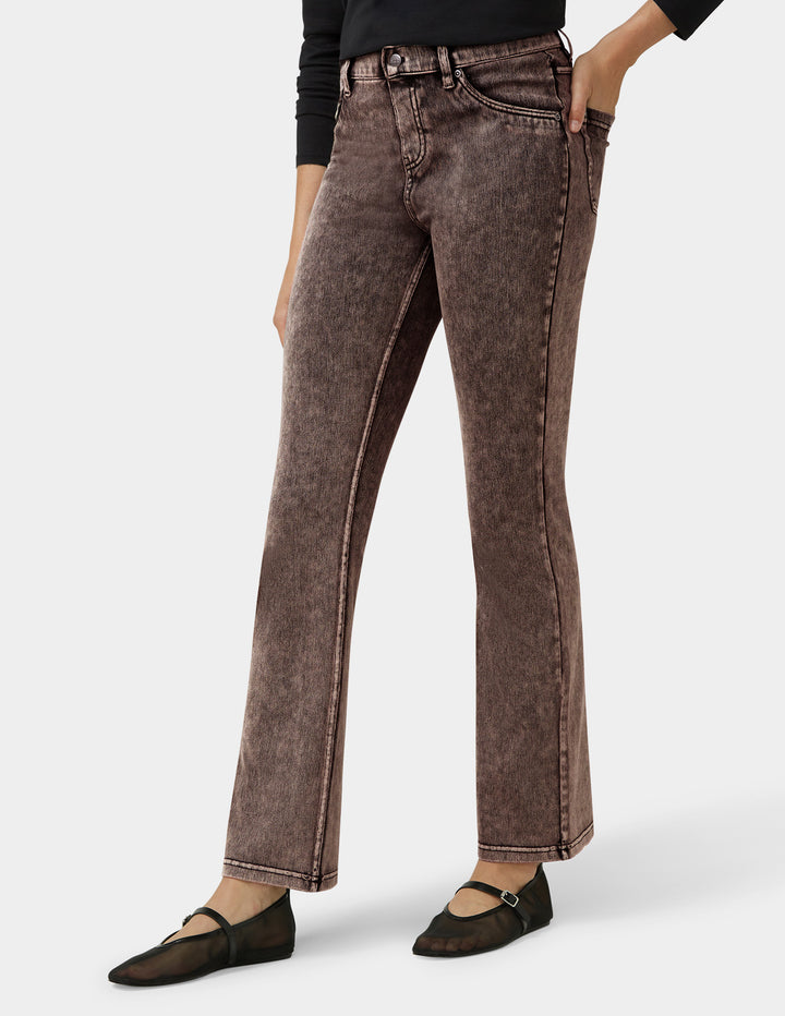 Brown straight-leg jeans worn by a person on a white background