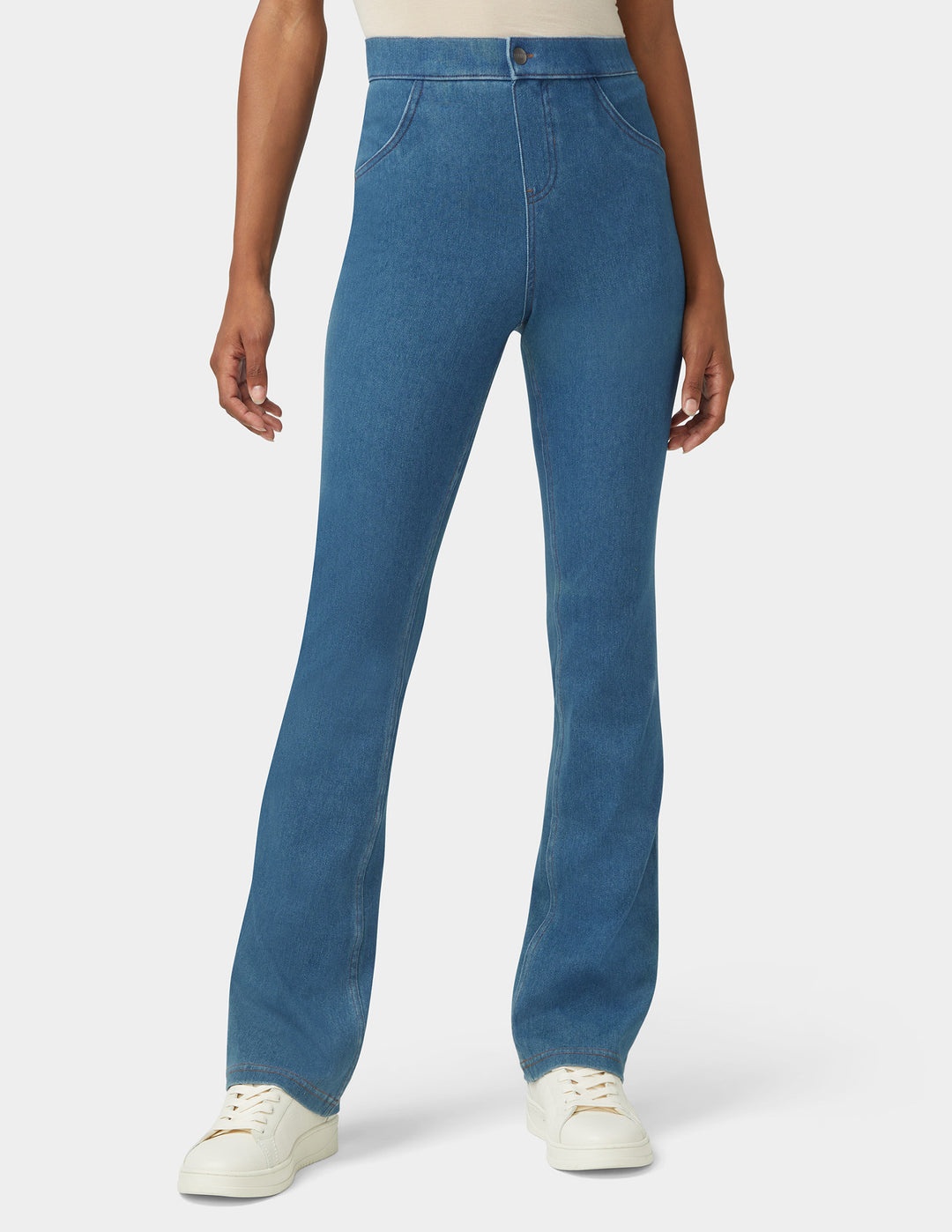 A model wearing bootcut medium wash bottoms