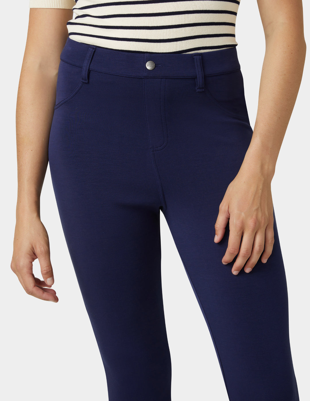 Navy blue pants worn by a person on a white background