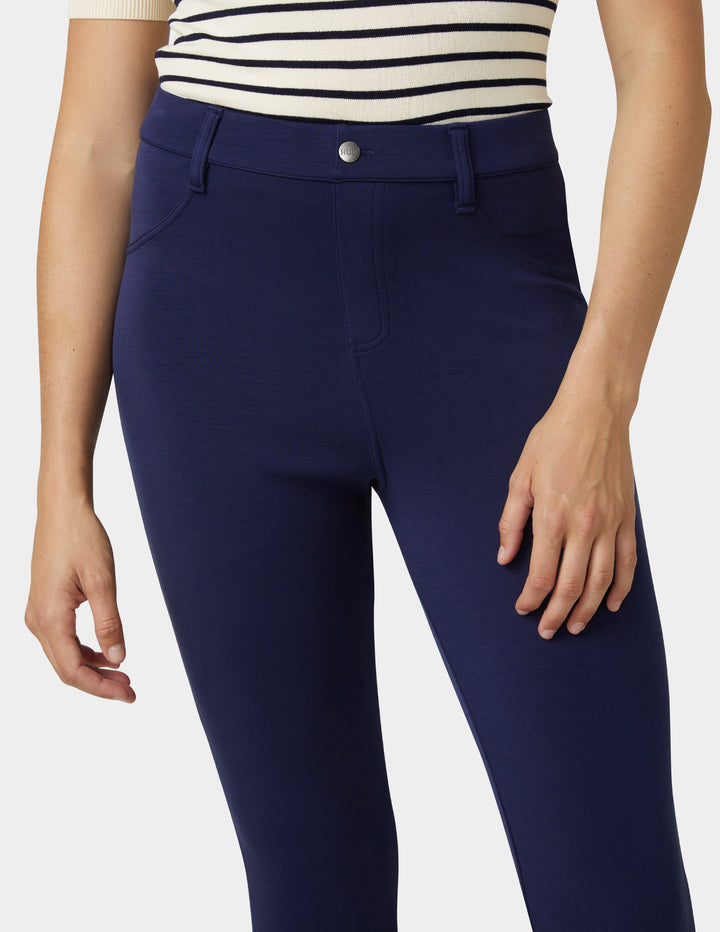 Navy blue pants worn by a person on a white background