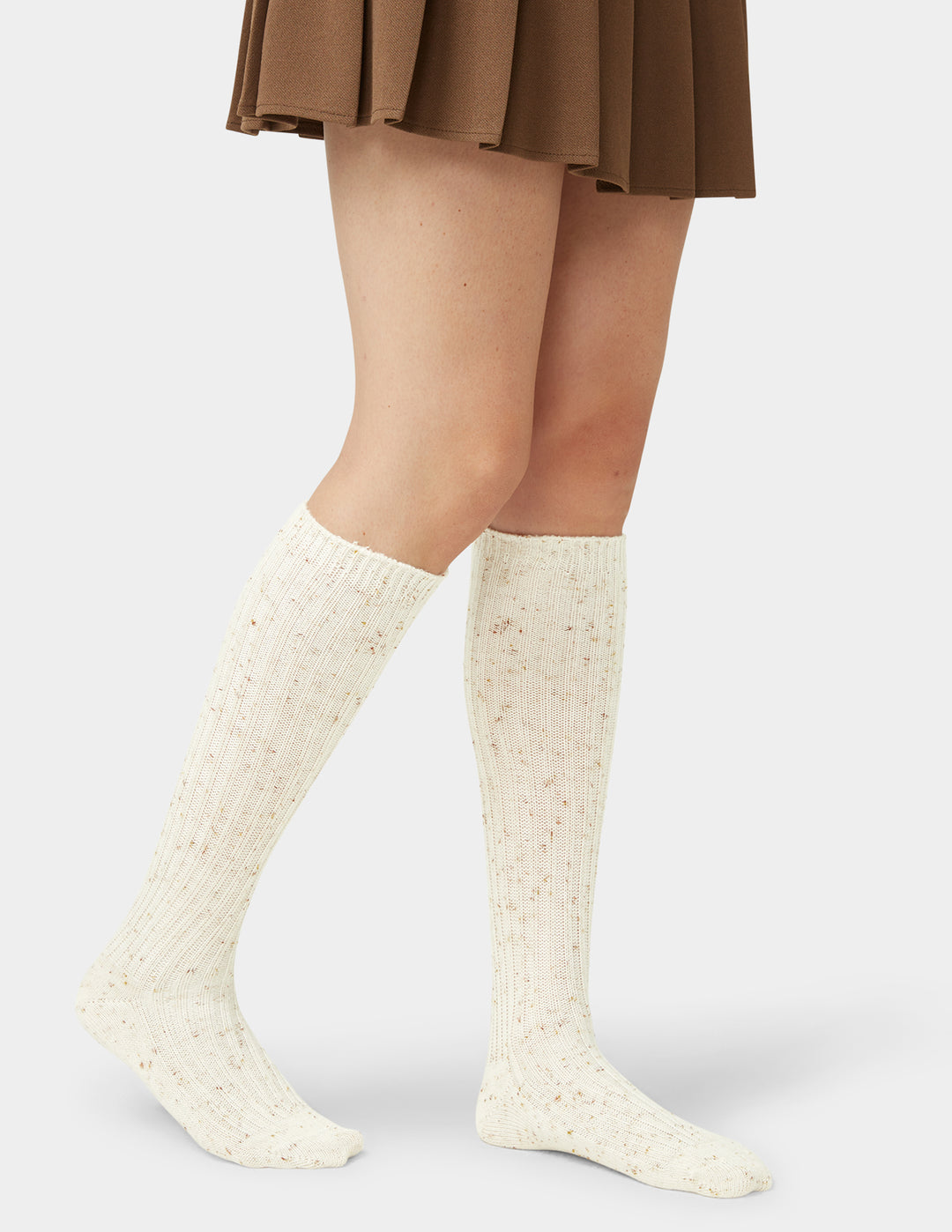 White knee-high socks worn with a brown skirt on a light gray background