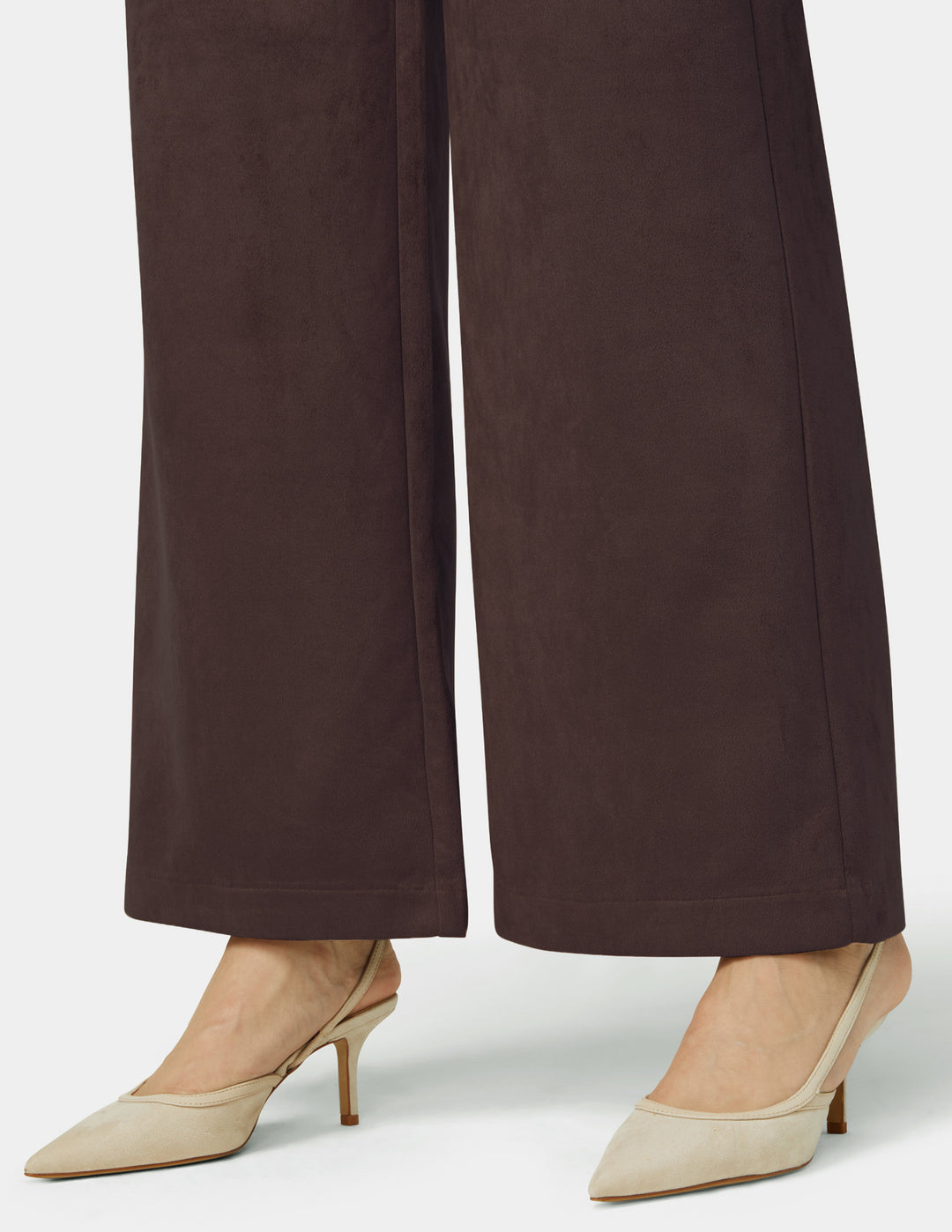 Brown wide-leg pants worn with beige high-heeled shoes on a white background