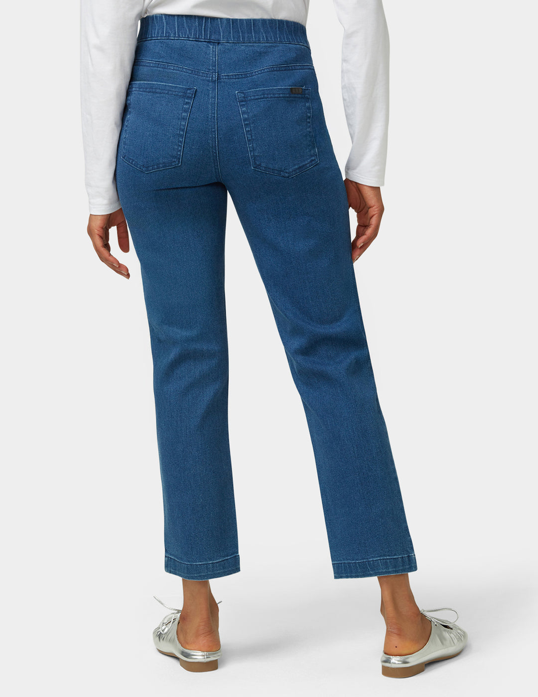 Blue jeans worn by a person on a white background