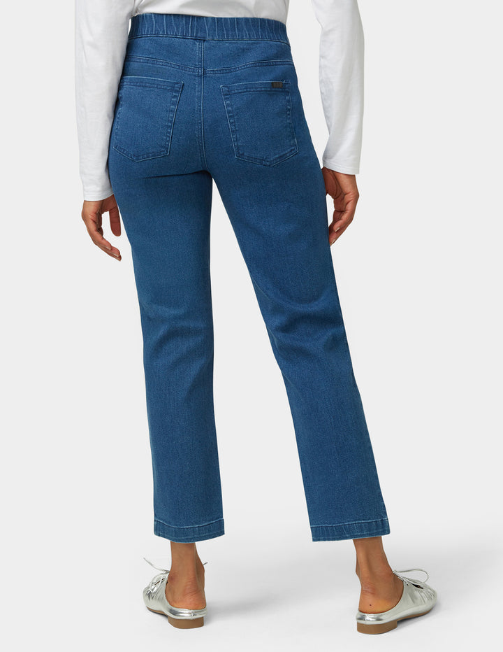 Blue jeans worn by a person on a white background