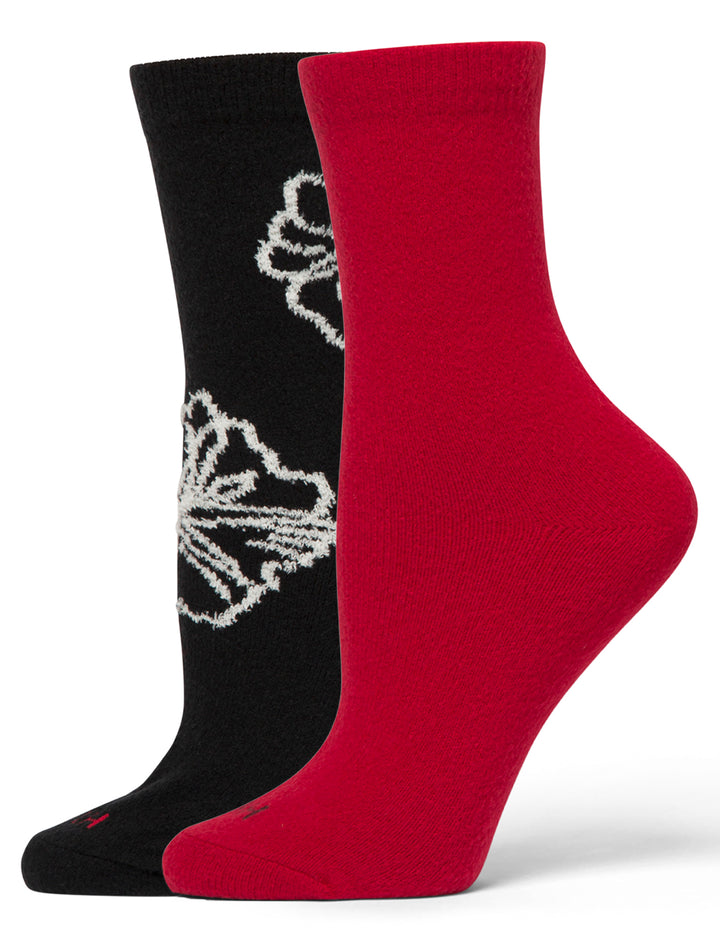 Two socks, one black with a white design and one red, on a white background