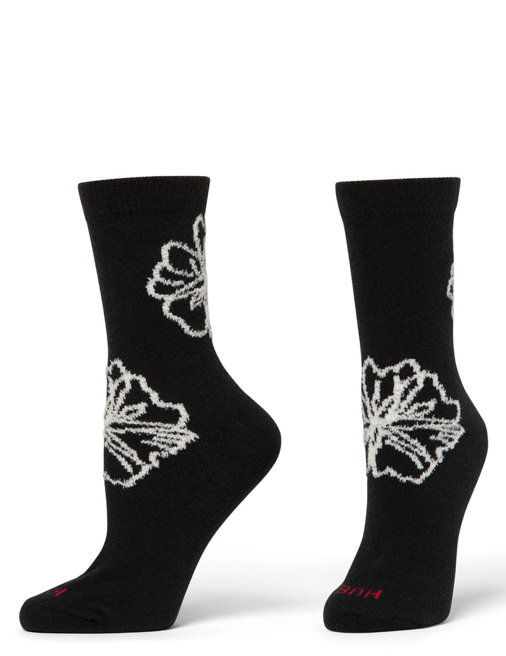 Black socks with white floral patterns on a white background