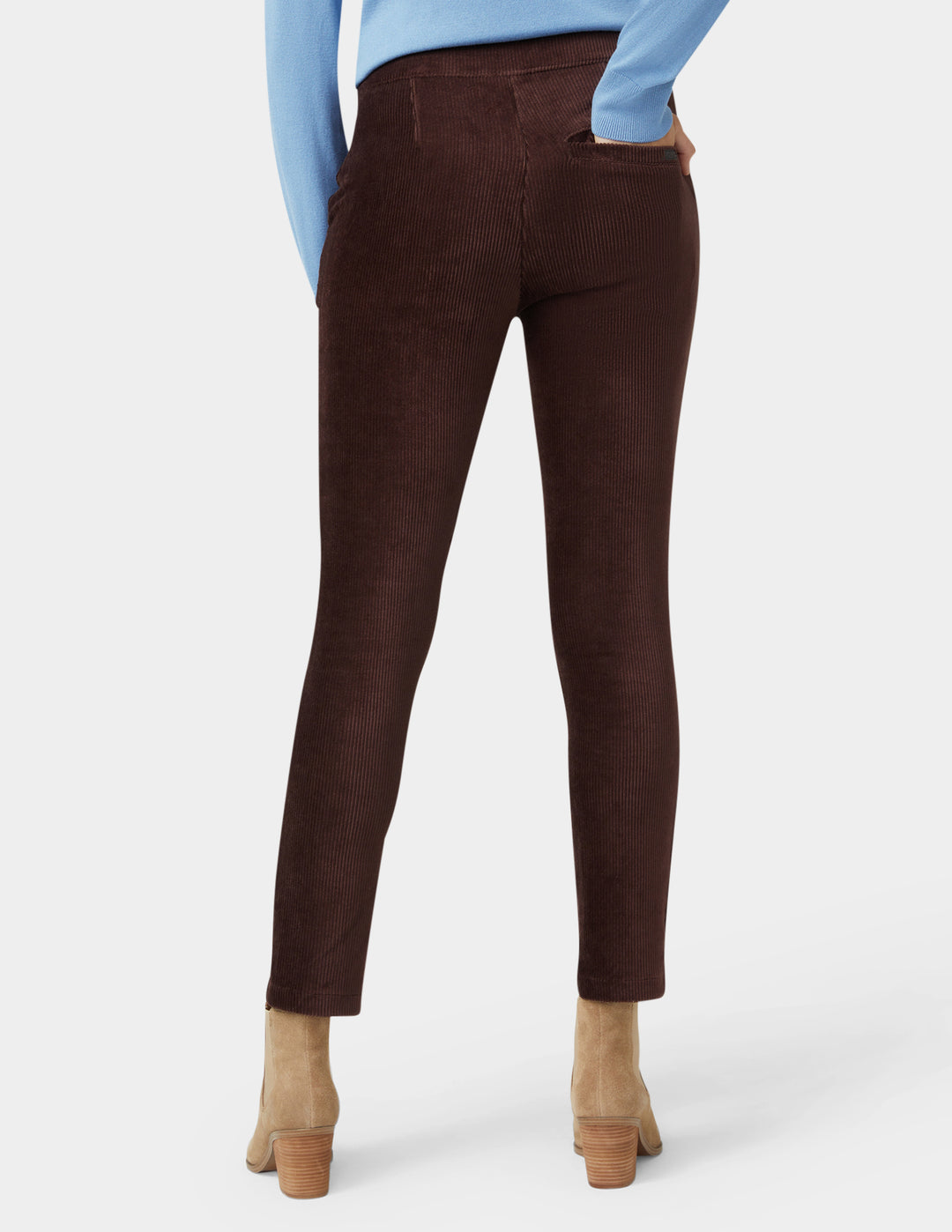 Brown pants worn by a person on a white background