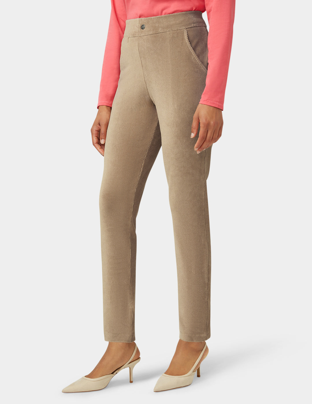 Beige pants worn by a person on a white background