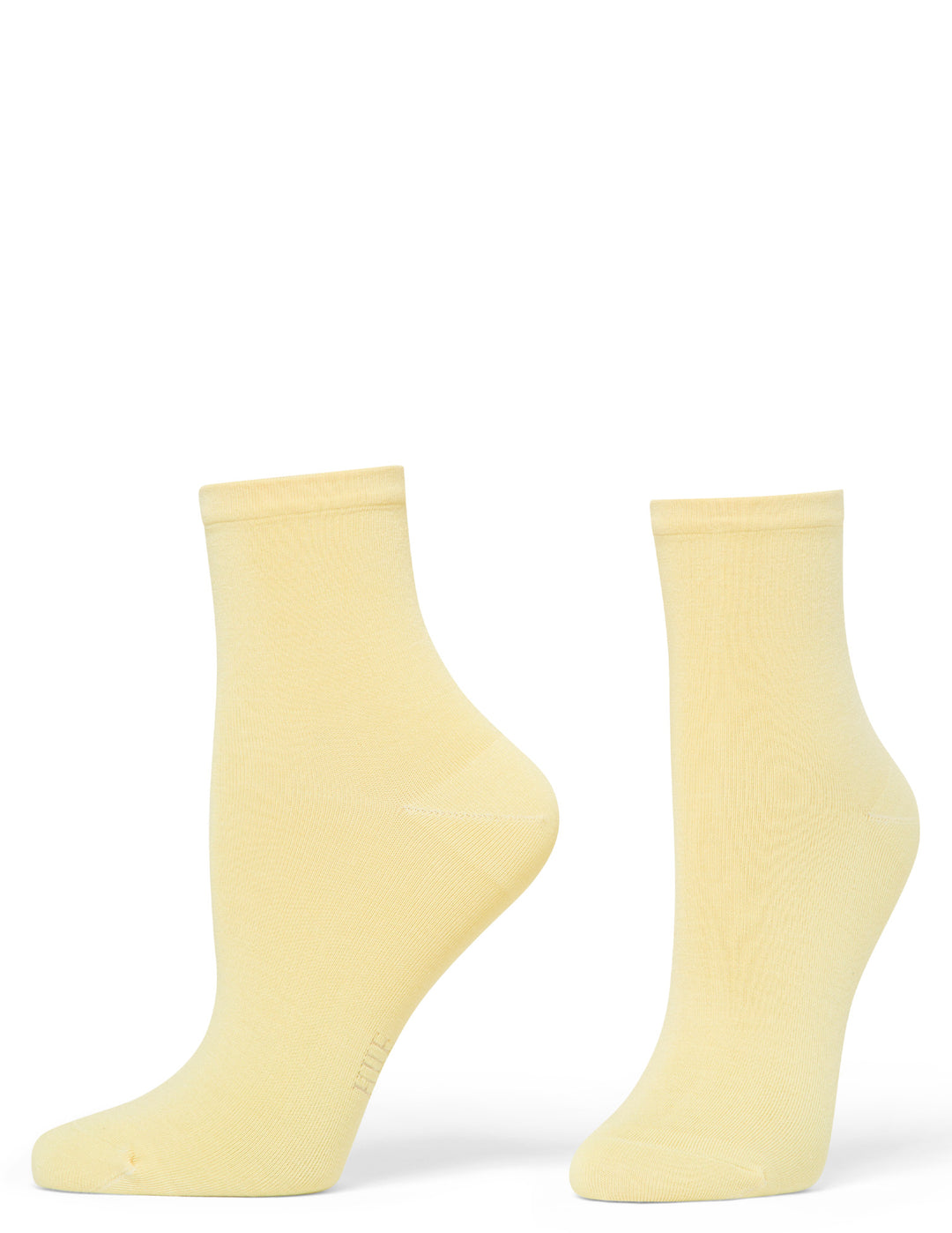 Pair of light yellow socks on a white background