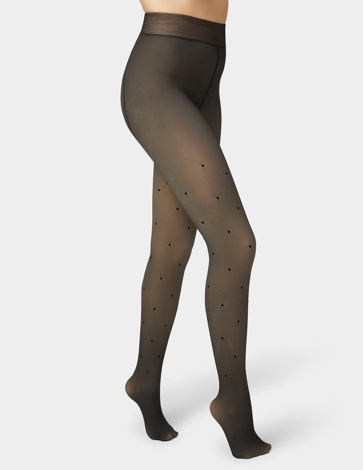 Faux sheer tights with black polka dots on a white background