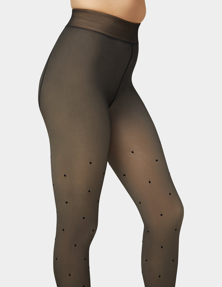 Faux sheer tights with black polka dots on a white background