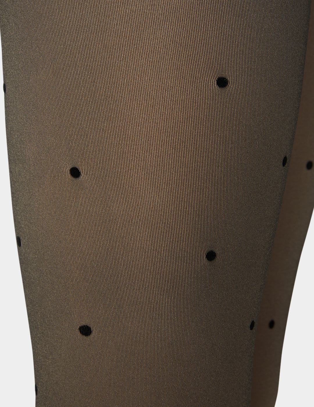 Faux sheer tights with black polka dot details on a white background