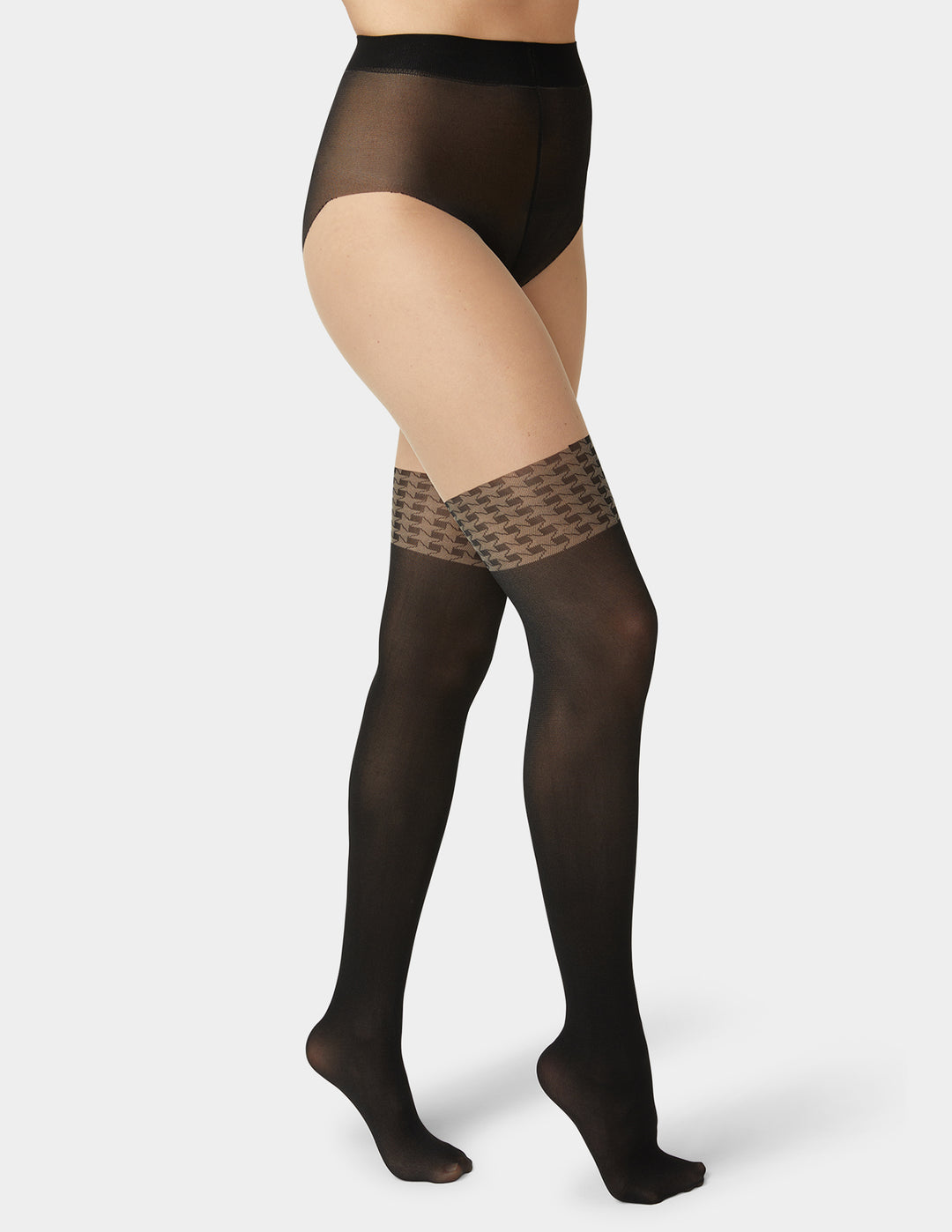 Black sheer stockings with patterned top worn by a person on a white background