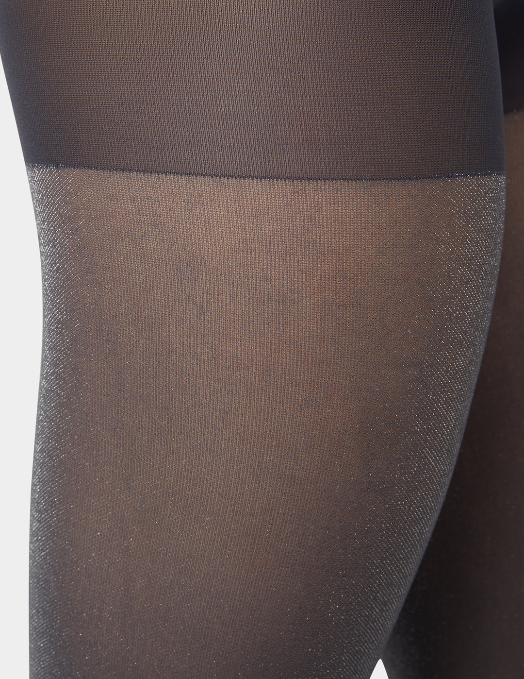 Close-up of silver grey metallic sheer tights worn by a person on a white background