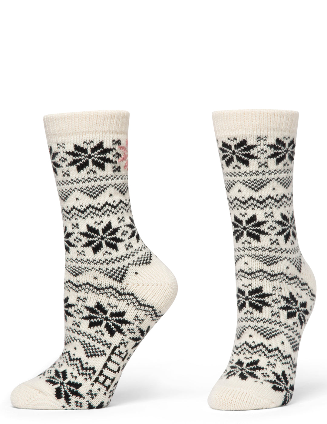 Pair of cream socks with black snowflake pattern on a white background