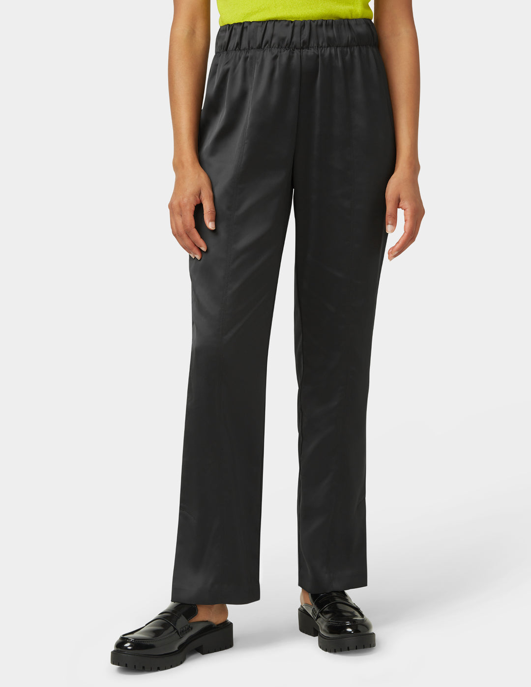 Person wearing black pants on a white background