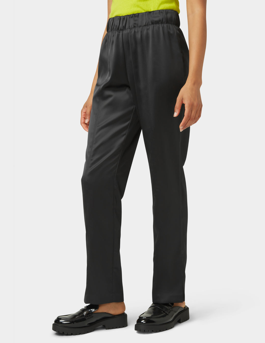 Person wearing black pants on a white background