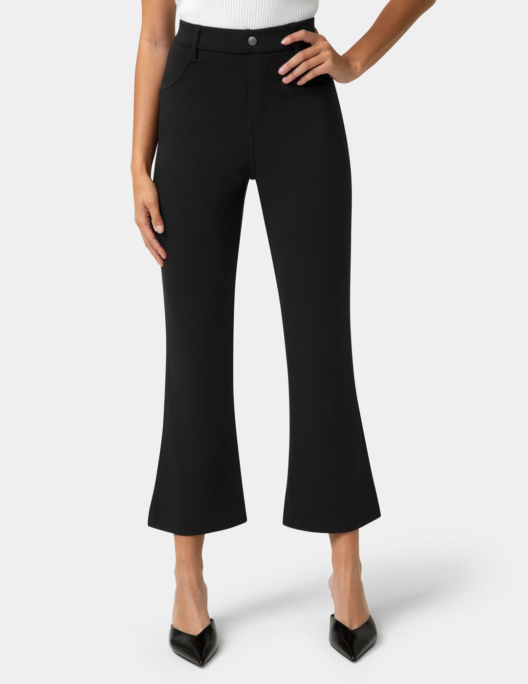 Black pants worn by a person on a white background