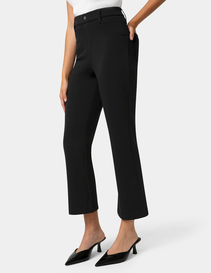 Person wearing black pants on a white background