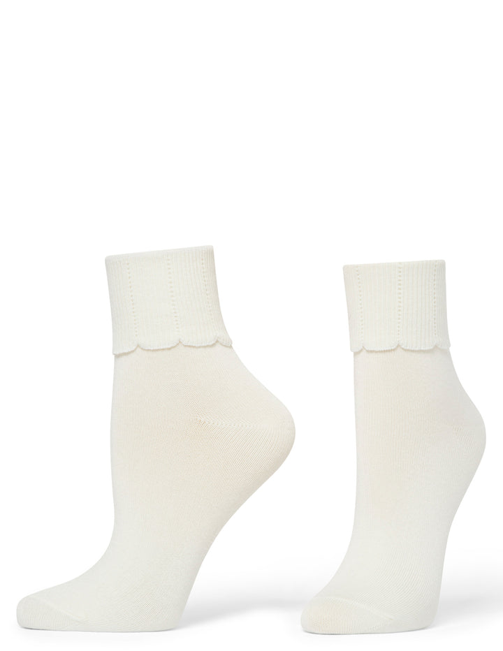 Two ivory socks on a white background