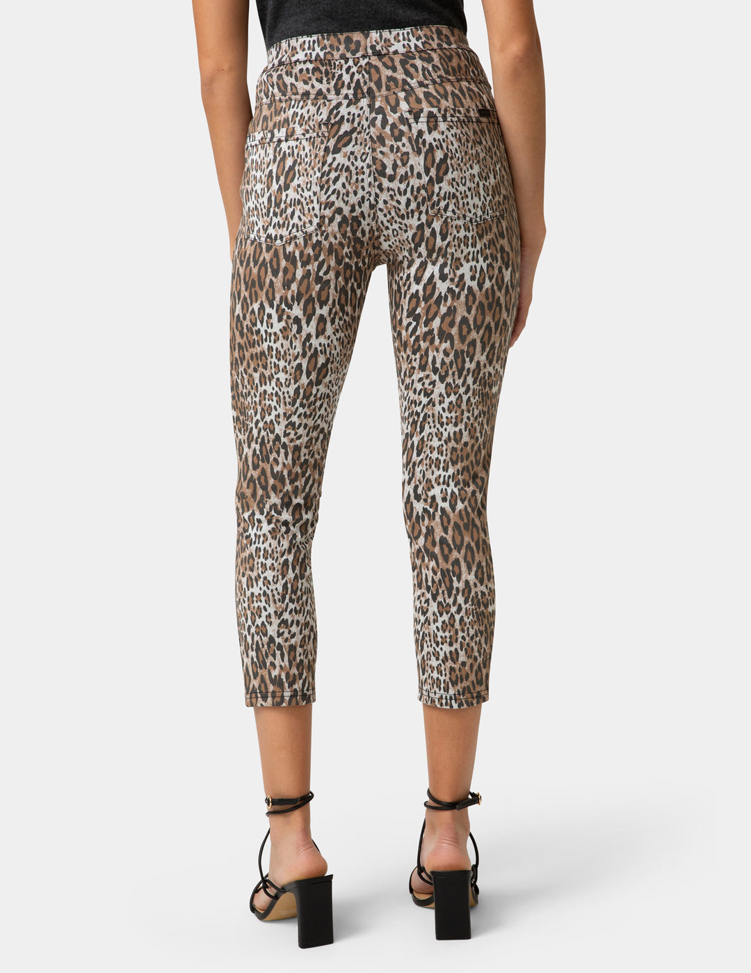 Leopard print pants worn by a person on a white background