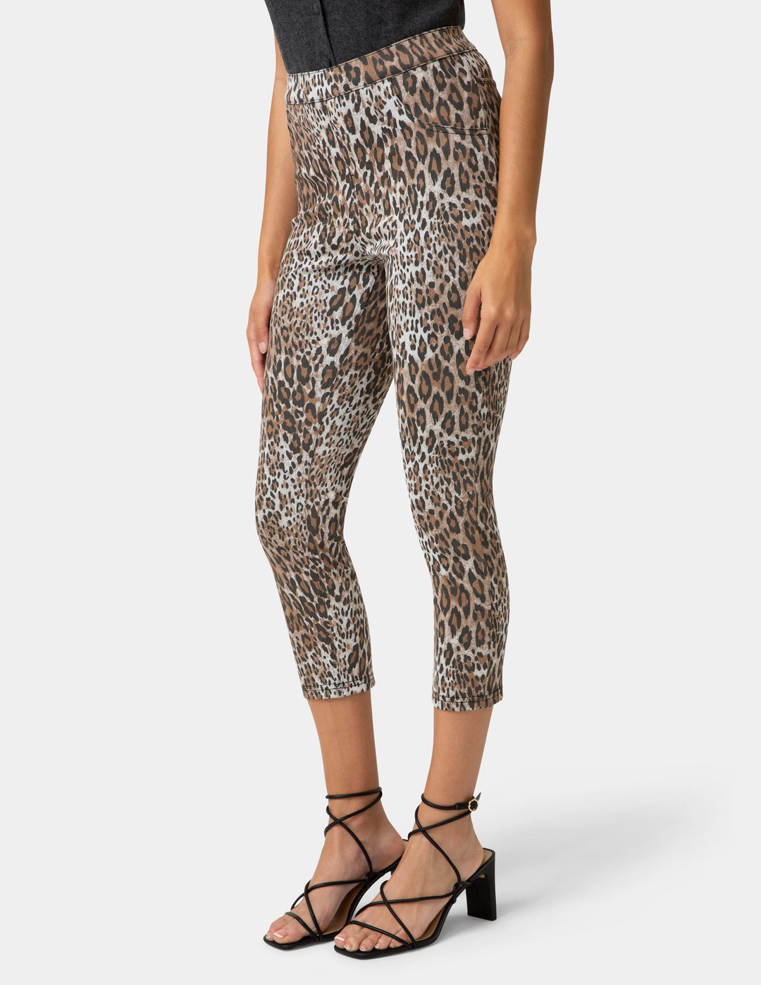 Leopard print pants worn by a person on a white background