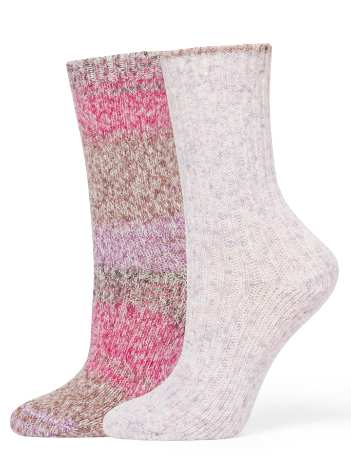 Two pairs of socks, one pink and brown patterned and one white, on a white background.