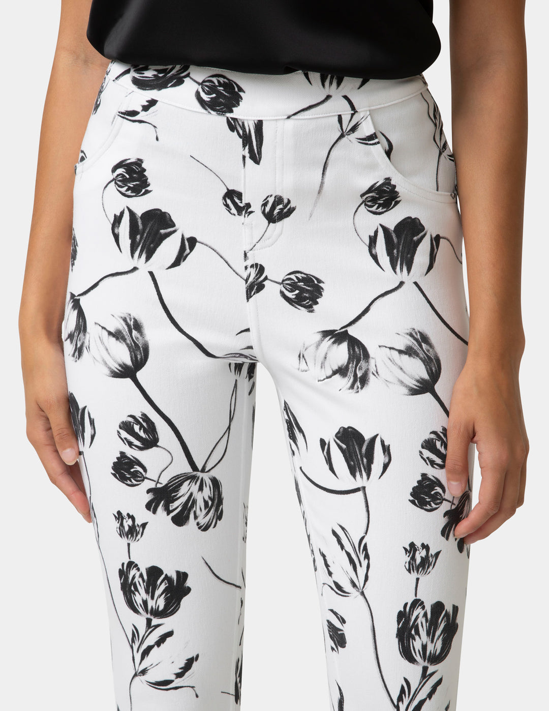 White pants with black floral pattern worn by a person