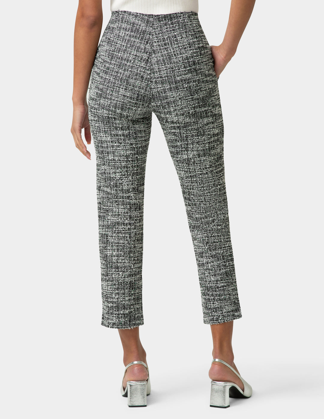 Person wearing patterned pants on a white background