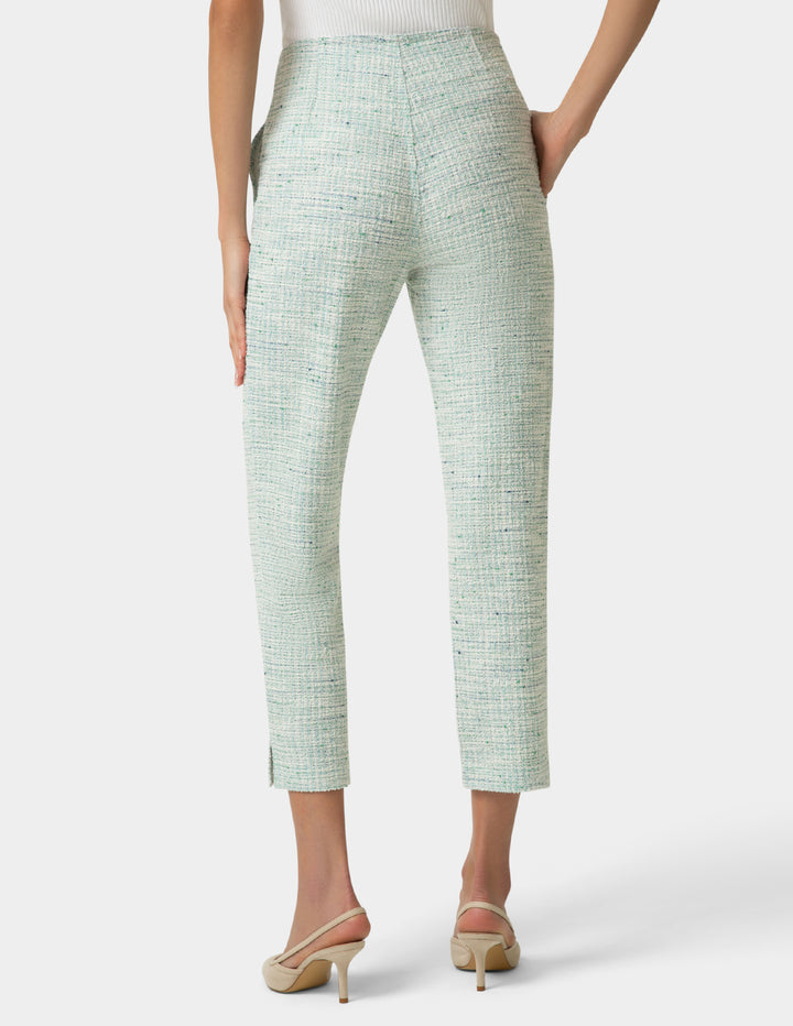 Mint green textured pants worn by a person on a white background