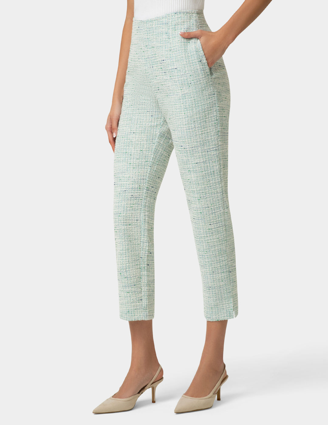Person wearing mint green textured  pants on a white background